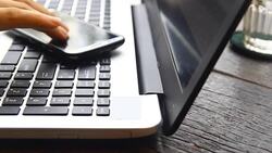 Handsome young businessman working at laptop with cup of coffee Stock Footage