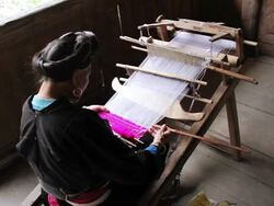 MS Old lady doing loom / Yao Village, Huangluo, China Stock Footage