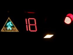 Crosswalk sign and traffic light at night. Stock Footage