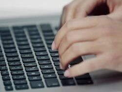 Woman typing on laptop Stock Footage