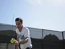LA MS DS Dolly in of a man bouncing and and getting ready to serve a tennis ball. Stock Footage