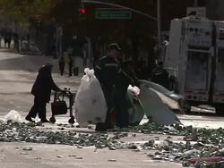 City maintenance workers load trash and other debris into plastic bags. Stock Footage