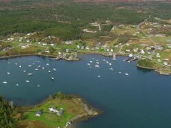 WS AERIAL View of Small motor boat floating in front of harbour / Maine, United States Stock Footage