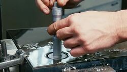Man in factory measure  hole in steel with vernier caliper. Stock Footage