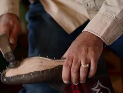 TU CU PAN R/F boot maker tacking vamp to sole of boot Stock Footage