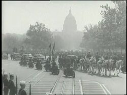 Men and women of different races and backgrounds including Harry and Bess Truman stand together as the funeral procession for President Franklin D. Roosevelt rolls by near the Capitol building in Washington, D.C. News Clip
