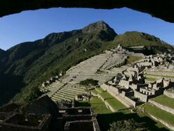 T/L, WS, sunrise Machu Picchu framed stone arch/ Peru Stock Footage