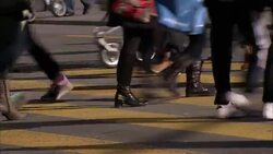 Pedestrians, strollers, and wheelchairs cross an intersection. Stock Footage