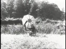 Winston Churchill sits in a field painting. News Clip