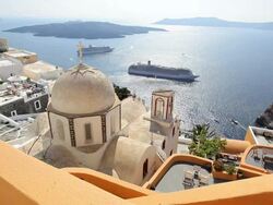 Dome of the local church and the white washed houses of Thira overlooking the Aegean Sea on the Island of Santorini, Greece, Europe Stock Footage