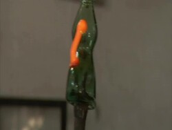 Glass blowing: molten glass attached to side of vessel and fashioned into handle, Egypt (sound available) Stock Footage