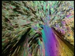 Rotation and zoom into different coloured diamond shaped crystals against black Stock Footage