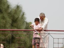 Senior man playing holi festival with his grandson at roof top  Stock Footage
