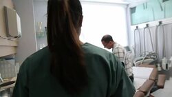 Nurse delivery test results to doctor and patient in examination room Stock Footage