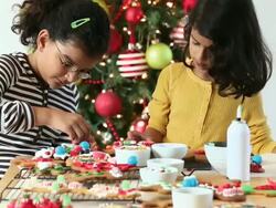 MS Two Young Sisters Decorating Gingerbread Cookies for Christmas / Richmond, Virginia, United States Stock Footage