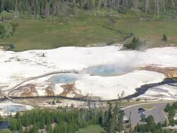 WS AERIAL View of Emerald Pool with car parking area and trees / Wyoming, United States Stock Footage