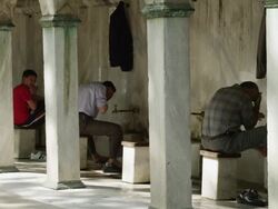 WS Row of men washing under outdoor taps at Blue Mosque portico / Istanbul,Turkey Stock Footage