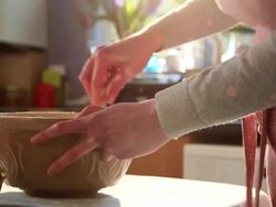 CU TU TD Shot of woman breaking egg in bowl sieving flour and mixing ingredients / London, Greater London, United Kingdom Stock Footage