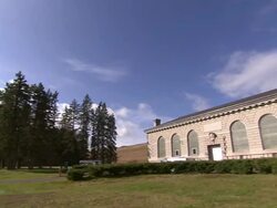 Nice landscaping surrounds a building with arched windows. Stock Footage