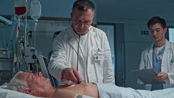 DS Doctor auscultating the patient in intensive care Stock Footage