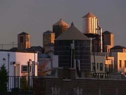 Sunlight and shadows fall across water towers in New York City. Stock Footage