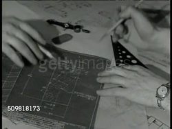 1944: JONES & LAMSON MACHINE CO.: DRAFT ROOM: INT WS Workers at tables in drafting room. MS Two men talking over blueprints, plans. CU Hands, designs. CU Sign 'Experimental Department.' VS Men testing, inspecting new machines & tools. Springfield, VT. Instructional Video