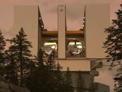 Medium zoom-in - The shiny disks of telescopes appear in the openings of a building / USA Stock Footage