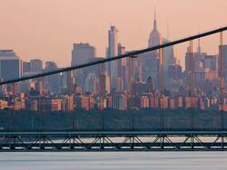 T/L View of traffic on the George Washington Bridge with the Manhattan skyline in the background at sunset Stock Footage