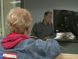 2009 MS Clerk assisting woman at counter in job center/ Antioch, California, USA/ AUDIO Stock Footage