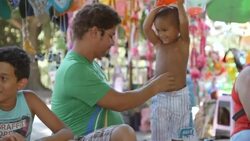 Brazilian kids attack dad with inflatable hammers at birthday party Stock Footage