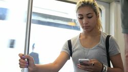 Teenage girl texting on bouncing train Stock Footage