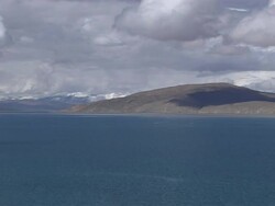 Pull back shot Rakshastal Lake with dense clouds Lhasa Tibet China Stock Footage