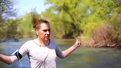 Young woman using a jump rope in park near river Stock Footage