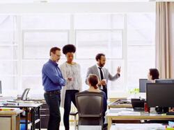 MS coworkers having informal project meeting next to workstations in architects office Stock Footage