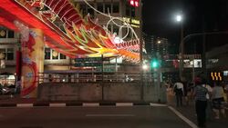 Pedestrians walk past a large, lit dragon decoration along New Bridge Road in Chinatown, Singapore as part of the Chinese New Year Celebrations. Stock Footage