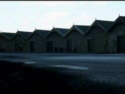 Runner Jogs On Street Past Boatsheds at Dawn, Dusk Stock Footage