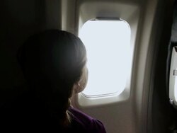 MS ZI Girl looking out through airplane window / Phoenix, Arizona, USA  Stock Footage