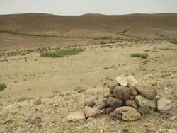 A pile of rocks on the open terrain, and the expanse of an untouched landscape. Stock Footage
