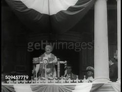 1933: U.S. PRESIDENT FDR IN HAWAII: WS Warship at sea. LA WS Franklin Roosevelt speaking at podium wearing lei '...I say to you Aloha from the bottom of my heart.' WS Crowd watching FDR leaving. LA WS FDR waving w/ hat from ship. MS Wake of ship. Instructional Video