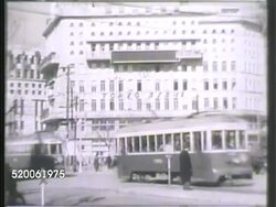 1942: TOKYO, JAPAN: * HA VS Busy city streets of Tokyo, including pedestrians, some in kimonos, automobiles, trolleys on cross streets, buildings, including 'Tokyo Asahi' & 'Mitsukoshi' (department store) buildings. Instructional Video