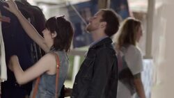 Young couple look at rustic shirts in Western shop and laugh Stock Footage