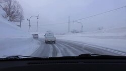 POV of car driving through the mountains during a snow storm. Stock Footage