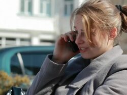 Young woman having not pleasant conversation on the phone outdoors Stock Footage