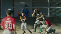 Wide slow motion panning shot of baseball batter hitting ball and running / American Fork, Utah, United States Stock Footage