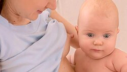 mother is nursing her infant Stock Footage