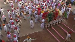 Diwali participants follow a procession through a crowded street in India. Stock Footage