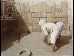 Bahrain 1960s - Archeologists excavating at the site of the Barbar Temple. An ancient seal is discovered, cleaned and printed. Stock Footage