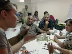 MS Young woman and older man having disagreement during small group discussion AUDIO / Bethlehem, Palestine Stock Footage