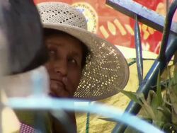 CU of woman in straw hat watching the world, La Cancha Market, Cochabamba, Bolivia Stock Footage
