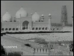 1951: MASJID: Mosque beyond gated window covering. LAHORE, PAKISTAN: HA XWS Badshahi Masjid (mosque) w/ huge courtyard filled w/ praying Muslims (not Moslems). WS Muslims rising from prayer. Landmark, Mughal era, religion, religious, community. Instructional Video